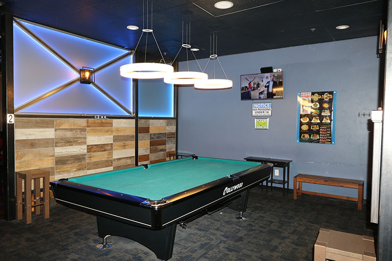 Billiards table with dividing wall and lights